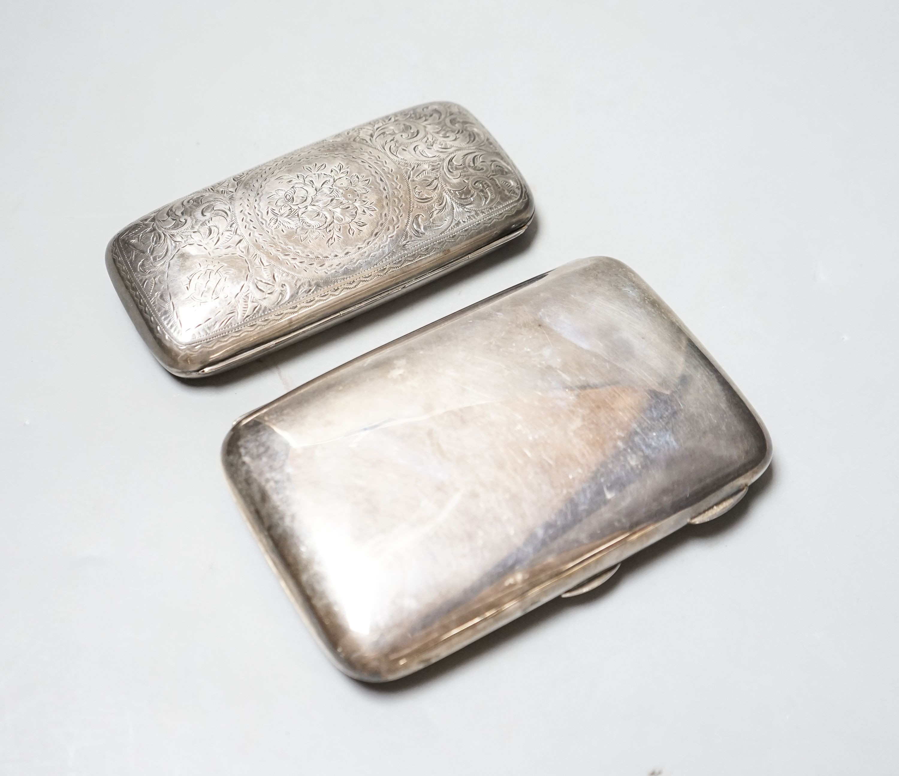 A late Victorian engraved silver cigar case, 13cm and a later silver cigar case, gross 11.5oz.